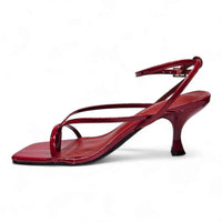 Red patent leather heeled sandal with align thong ankle strap and ankle strap kitten heels