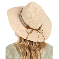 Beige straw sun hat with boho pattern band, perfect for stylish summer outings