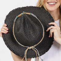 Black straw sun hat with decorative braided starfish band accessory
