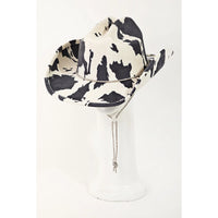 Cow Print Draw String Cowboy Hat featuring a stylish black and white cow print pattern