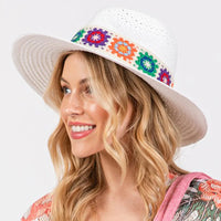 White sun hat with colorful floral crochet band for stylish summer wear