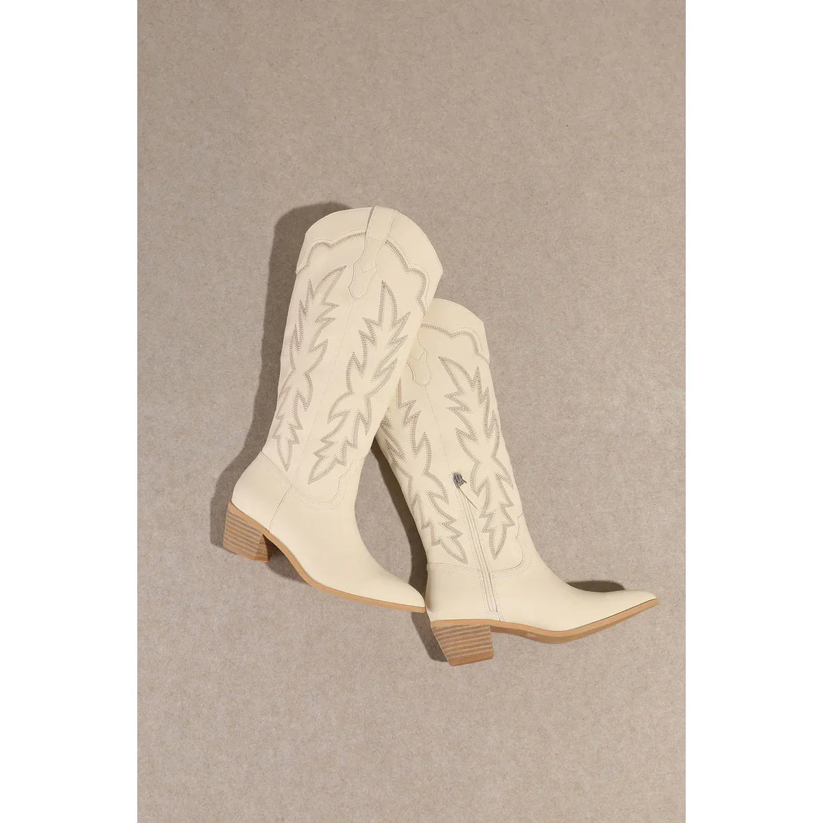 White leather Samantha Knee-High Western Boots with embroidered stitching and wooden heels