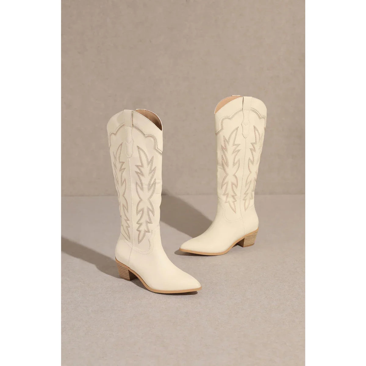 White leather Samantha Knee-High Western Boots with decorative stitching and pointed toes