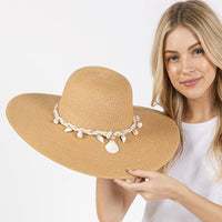 Wide brim straw sun hat with shell embellishments and braided band for stylish sun protection