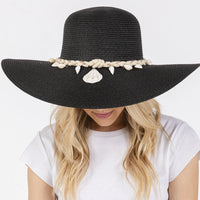 Black wide brim straw sun hat with shell embellishments and braided band for stylish sun protection