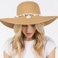 Wide brim straw sun hat with seashell accents and braided band for stylish sun protection