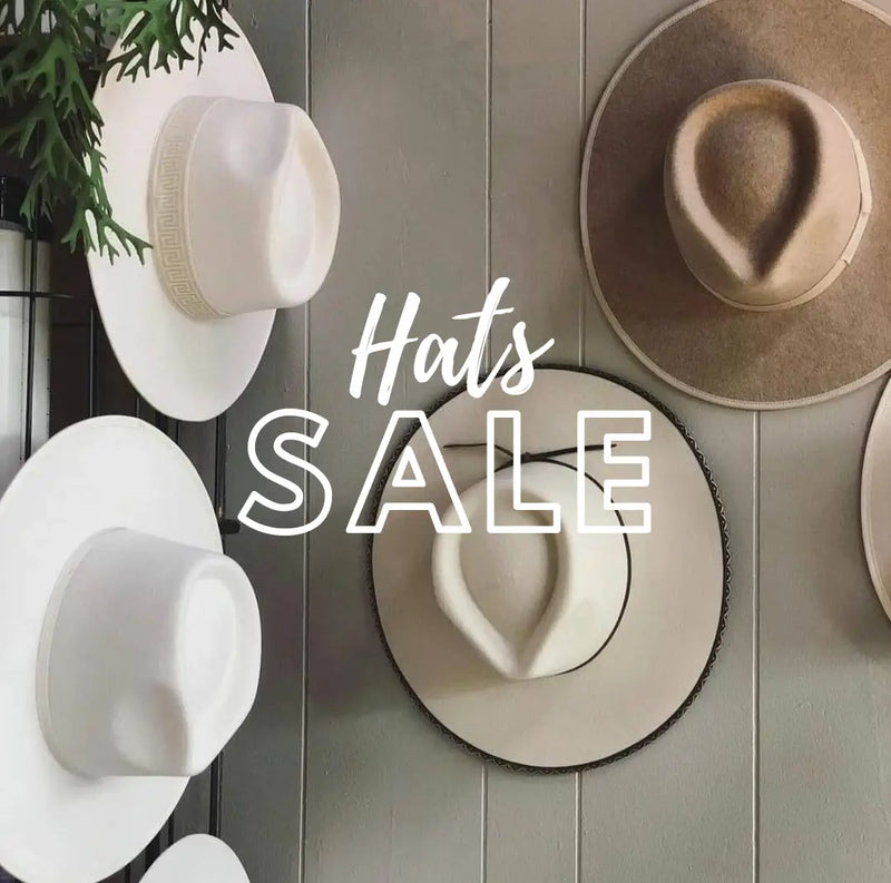 Wide-brimmed white and beige hats in Del Mar’s women’s sale for unbeatable deals.