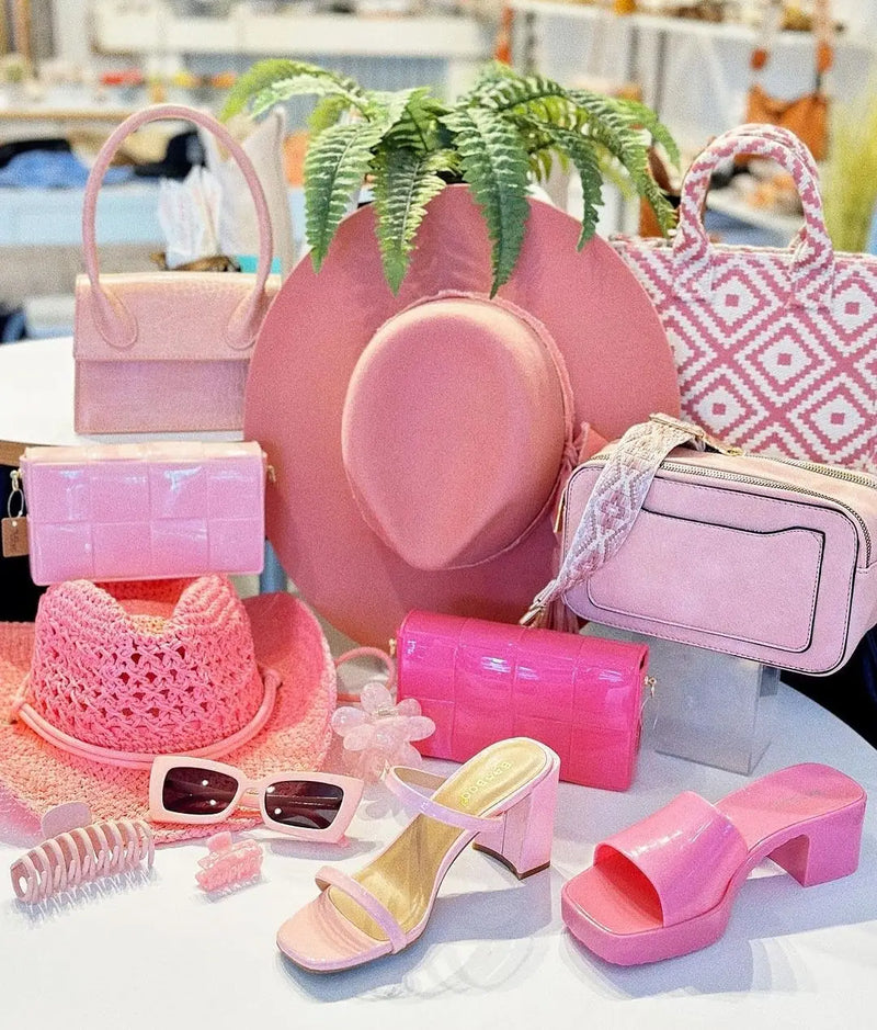 Pink wide-brimmed hat with fern, perfect accent for women’s bags and accessories collection.