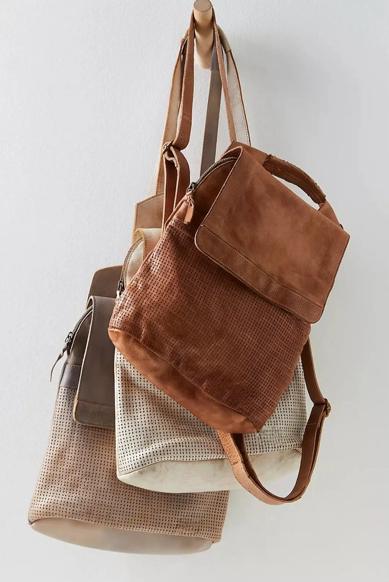 Collection of earthy tone leather and fabric handbags including Del Mar’s guitar strap sling.