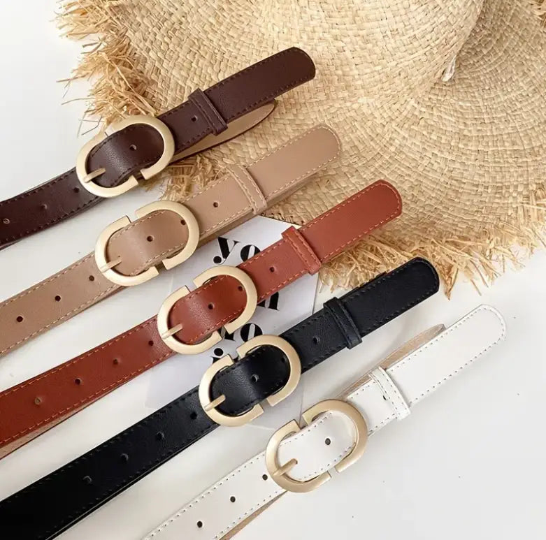 Collection of leather belts with gold-colored buckles in Del Mar’s Collection