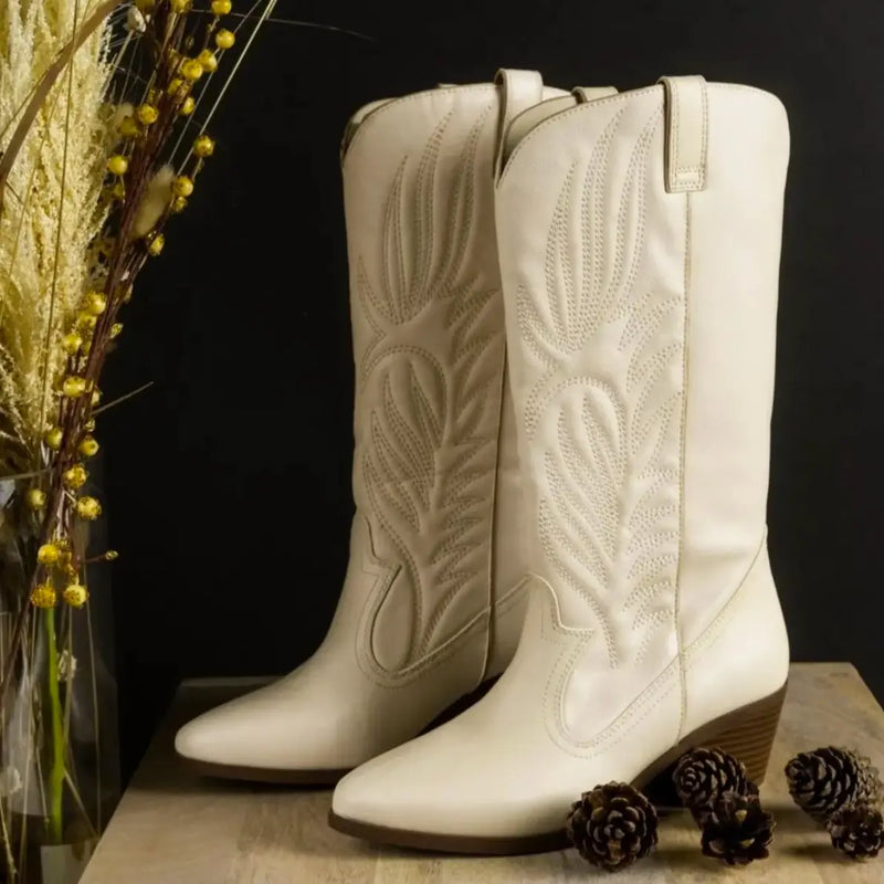 White leather cowboy boots with decorative stitching in the Boots collection.