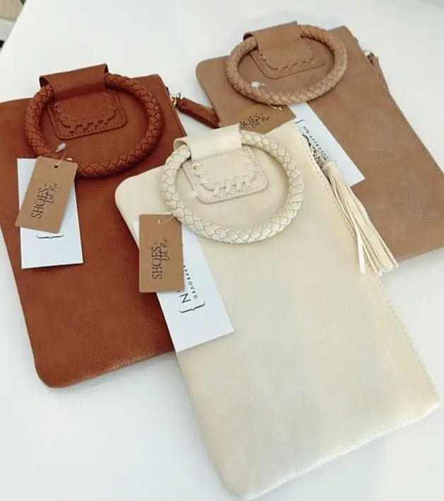 Del Mar’s exquisite collection of earth-tone leather clutches and wristlets with braided handles