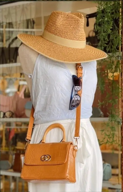 Mannequin in white dress showcasing Del Mar’s bamboo handle Tori crossbody bag.