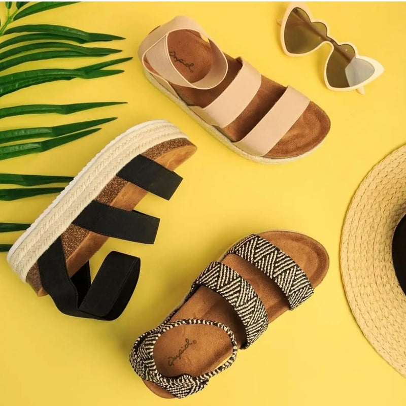 Collection of Del Mar women’s platform sandals and accessories on bright yellow background