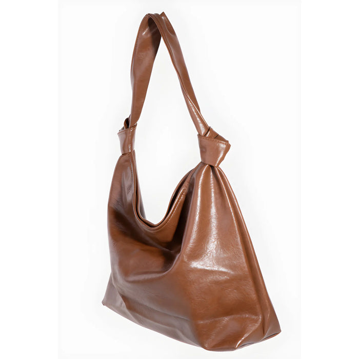 Brown leather hobo bag with knotted strap showcasing a weathered faux leather tote bag