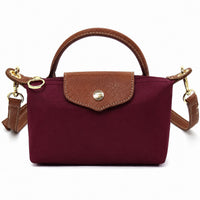 Mini tote bag in burgundy with tan leather-look trim, front flap pocket, gold hardware