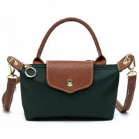 Mini tote bag in dark green with tan front flap pocket, leather-look handles, gold hardware