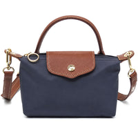 Mini tote bag in navy with tan front flap pocket, leather-look handles, gold hardware