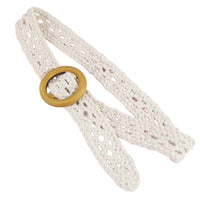 White lace belt with a wooden buckle on a pink background