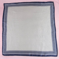 Navy blue border on a white spotted scarf 