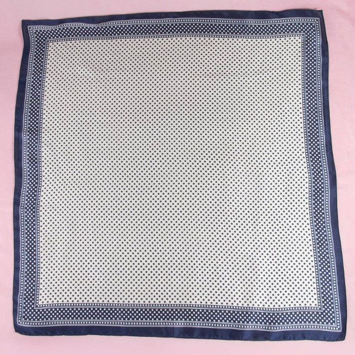 Navy blue border on a white spotted scarf 