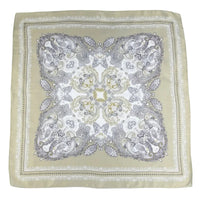Decorative square cloth with intricate paisley pattern on a cream background