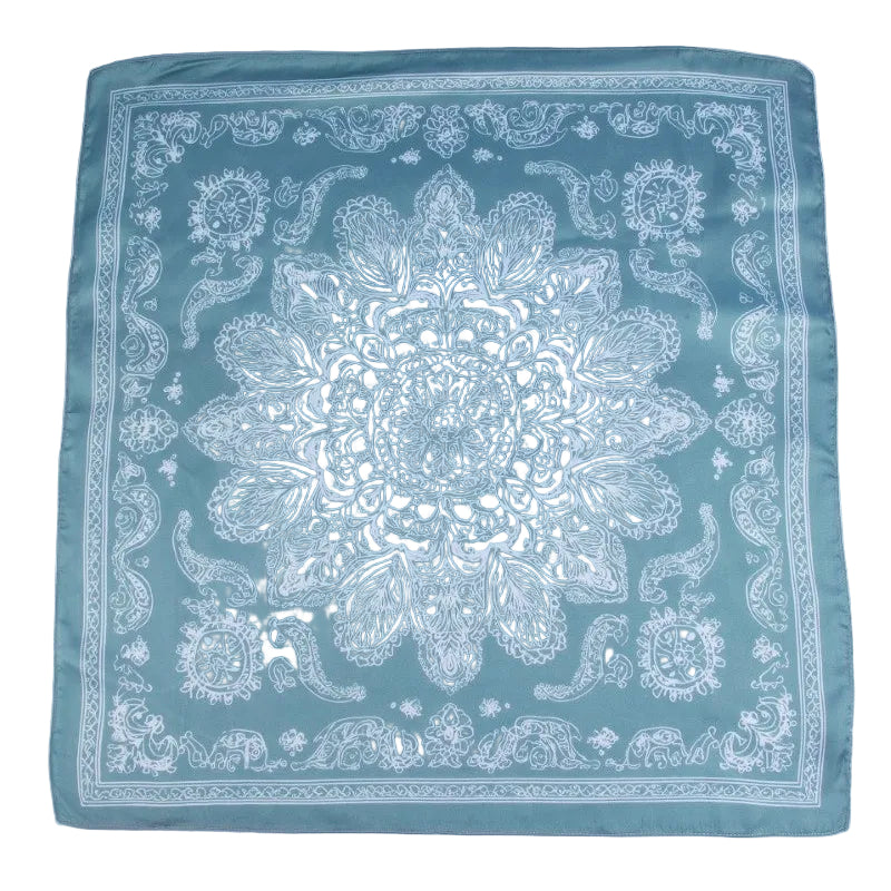 Teal bandana with white paisley pattern on a light gray background