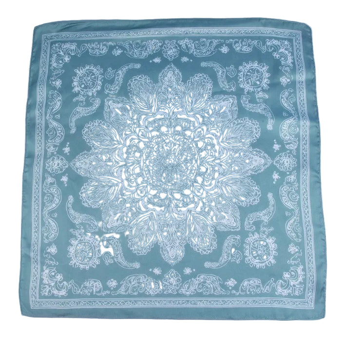 Teal bandana with white paisley pattern on a light gray background