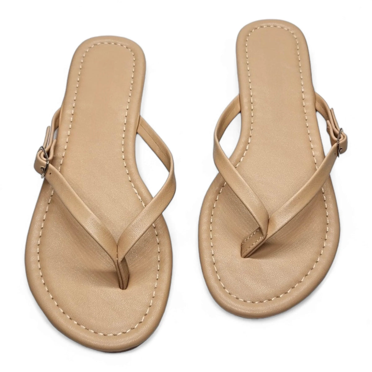 Beige leather flip flops with thin straps and buckle closures for adjustable fit