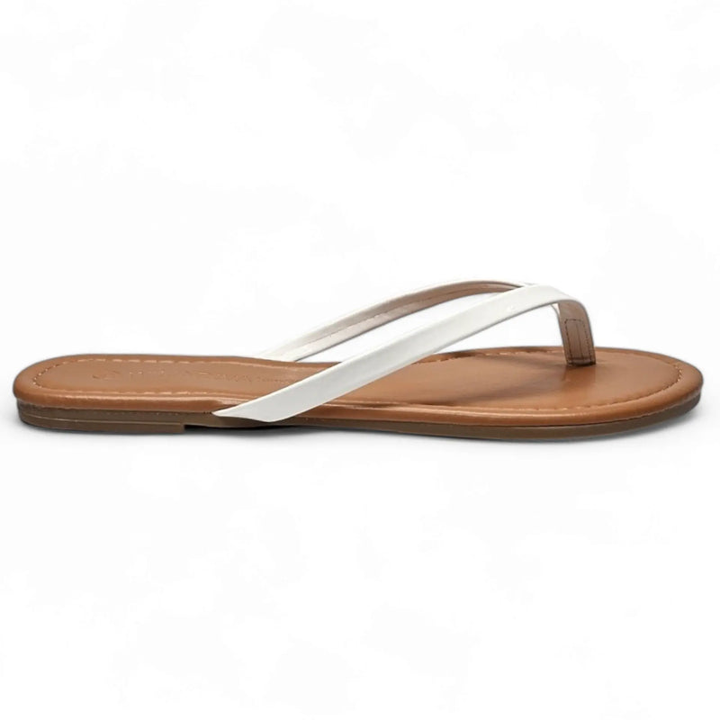 White leather thong sandal with flat brown sole for stylish summer flip flops