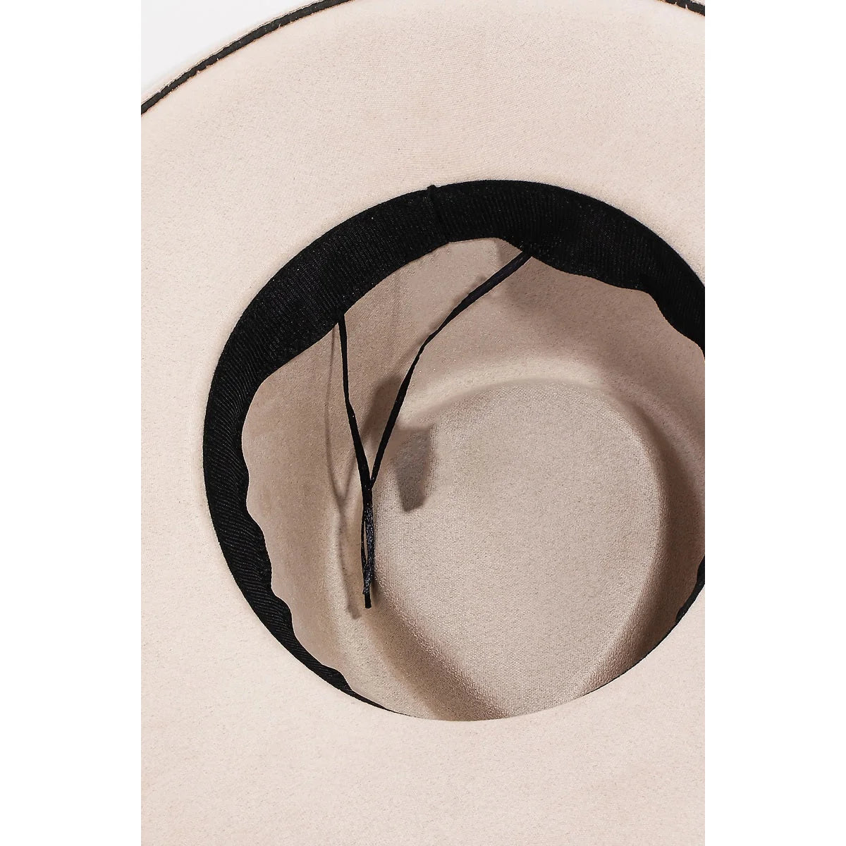 Cream-colored cowboy hat with a black band and braided pattern strap detail