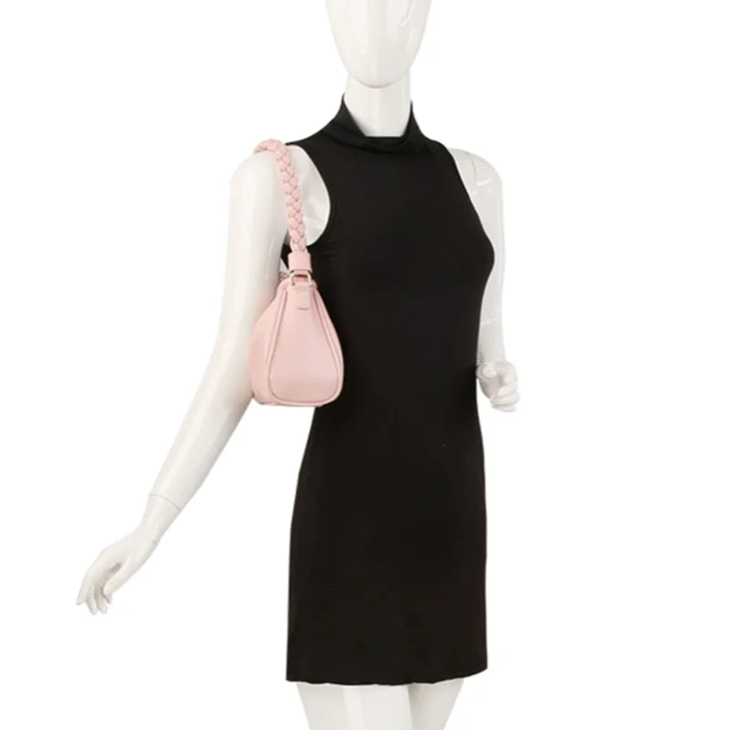 Black sleeveless mini dress on mannequin paired with a Braided Strap Shoulder Bag