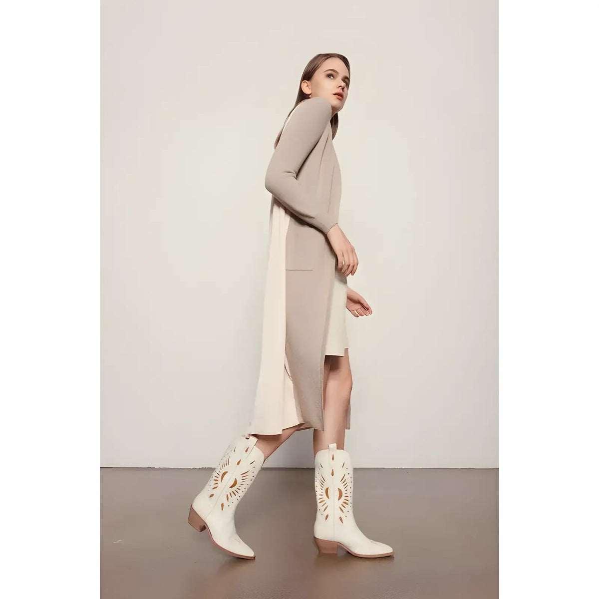 Beige knit dress with side slits paired with white Western boots from Britney Cut Out