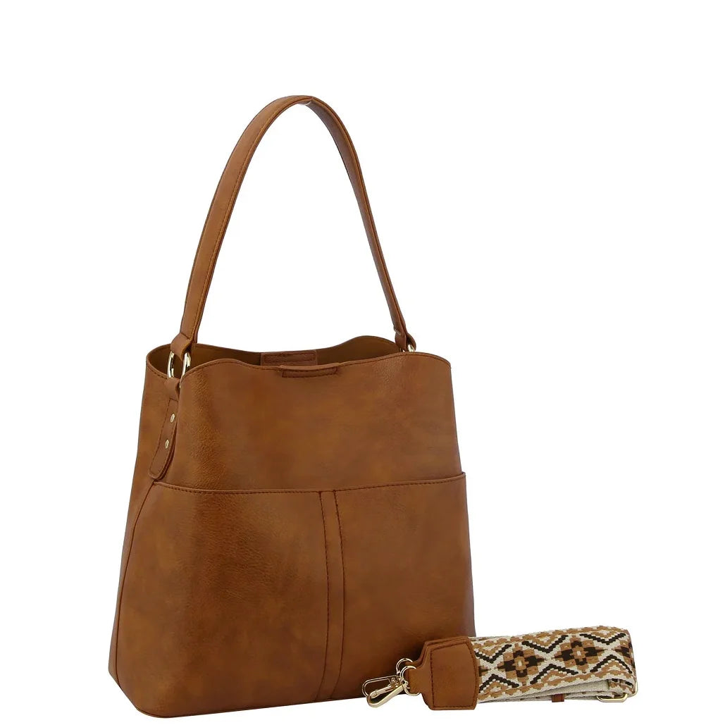 Brown leather Bucket Hobo Bag with guitar strap and stylish accessories displayed