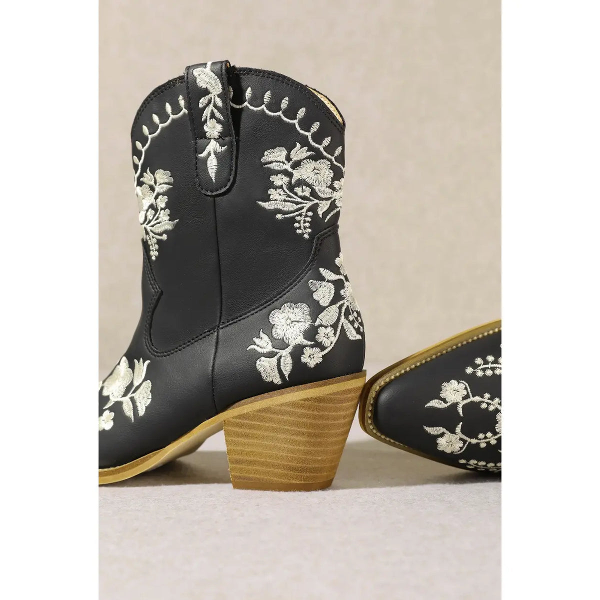 Black Carolina Flora Cowgirl Bootie with white floral embroidery and wooden heel