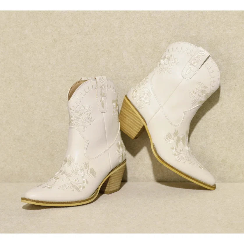 Pair of white Carolina Flora Cowgirl Booties with pointed toes and wooden heels