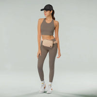 Woman in athletic wear with CC Waterproof Belt Bag, a stylish fanny belt bag