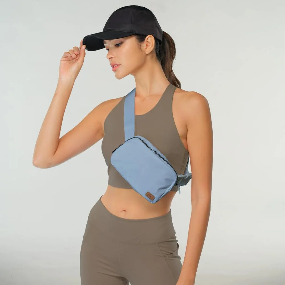 Woman in athletic wear with a baseball cap showcasing the CC Waterproof Belt Bag