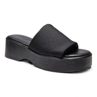 Black platform slide sandal featuring a thick sole and wide band wedge design