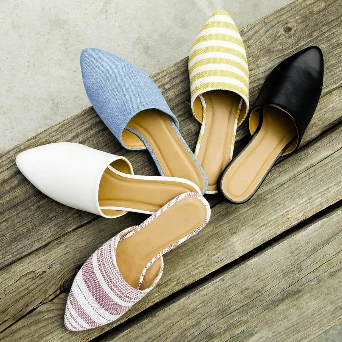 Collection of flat mule shoes in different colors and patterns.