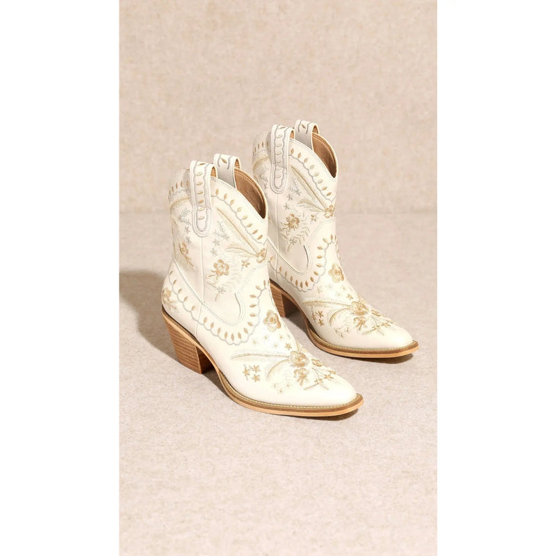 Ornate white cowboy boots with intricate embroidery, Corral Cowgirl Bootie style