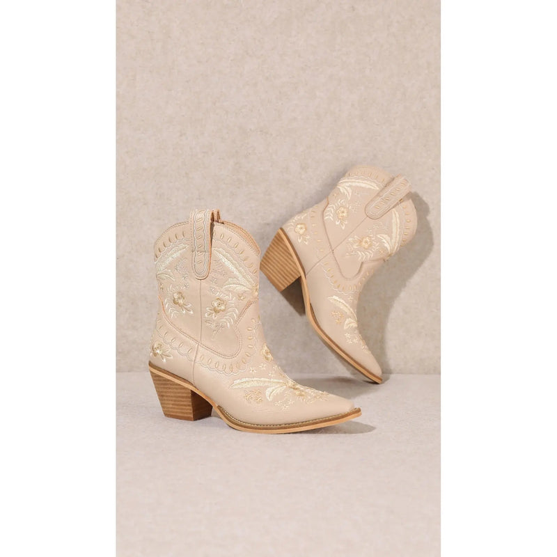 Cream-colored Corral Cowgirl Bootie with embroidered designs and pointed toes