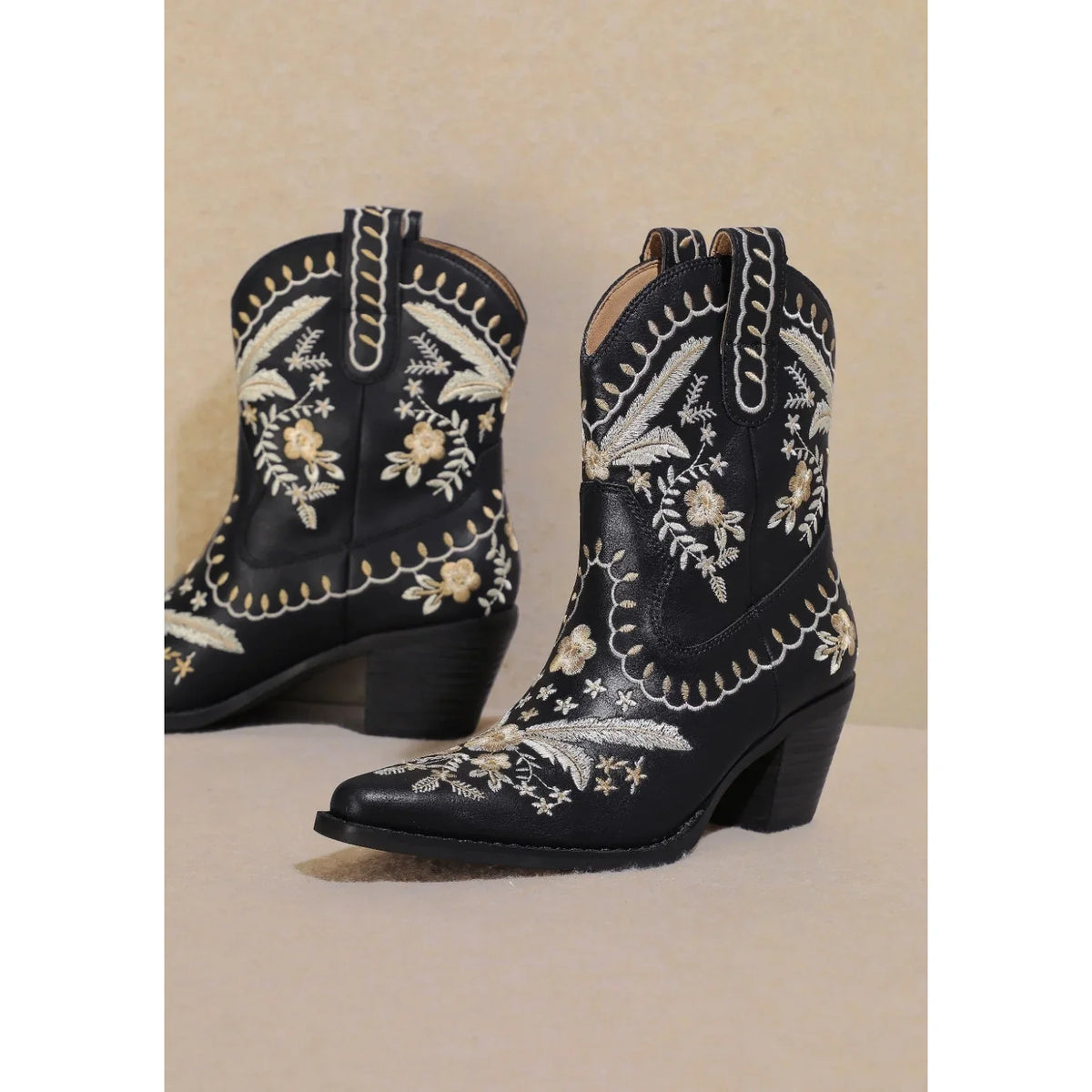 Pair of black Corral Cowgirl Booties with intricate white floral embroidery