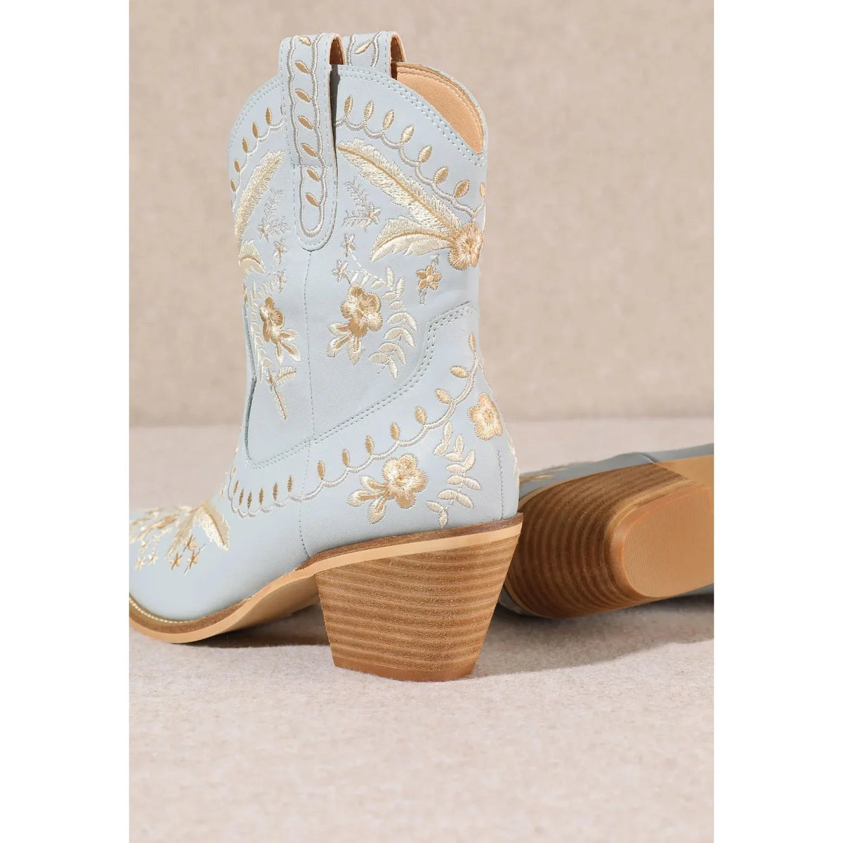 Pale blue Corral Cowgirl Bootie with gold floral embroidery and wooden heel