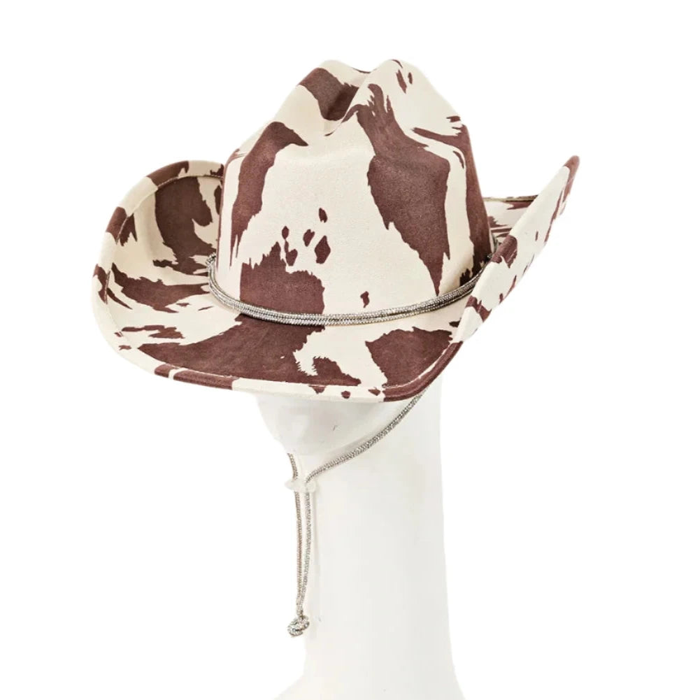 Cow Print Draw String Cowboy Hat with brown and white cowhide pattern on glass