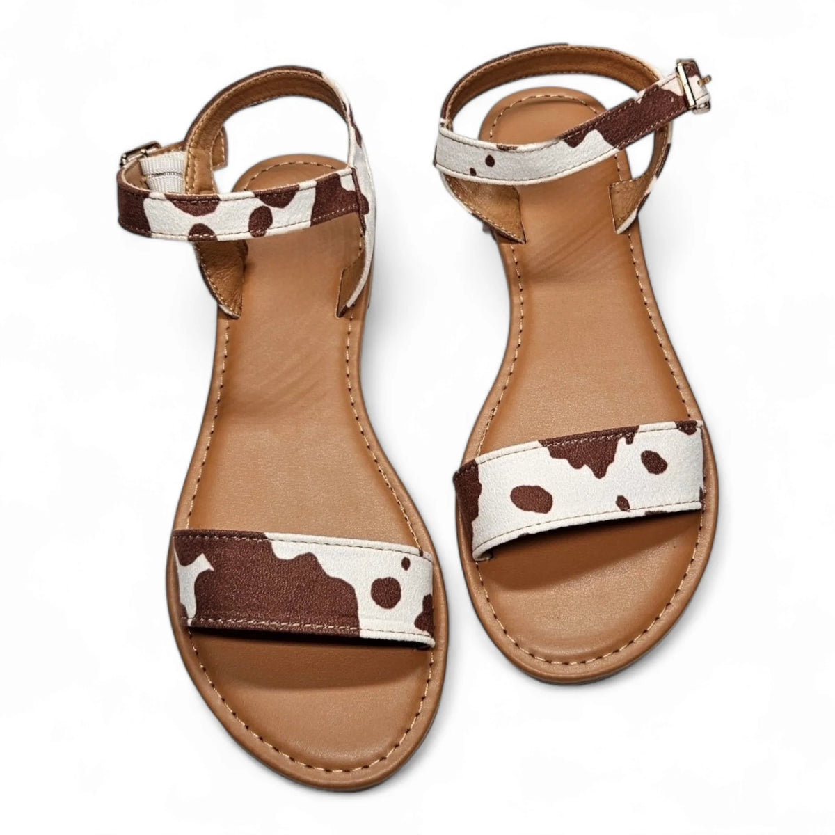 Cow Print Sandal featuring stylish cow print straps and brown leather soles