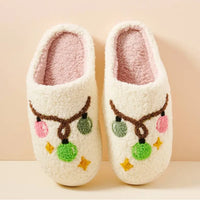 White fuzzy Cozy Christmas Light Bulb Slippers with colorful pom-poms and star designs