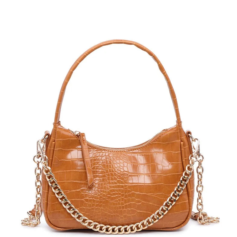 Tan crocodile shoulder bag with curved handle and gold chain strap for stylish elegance