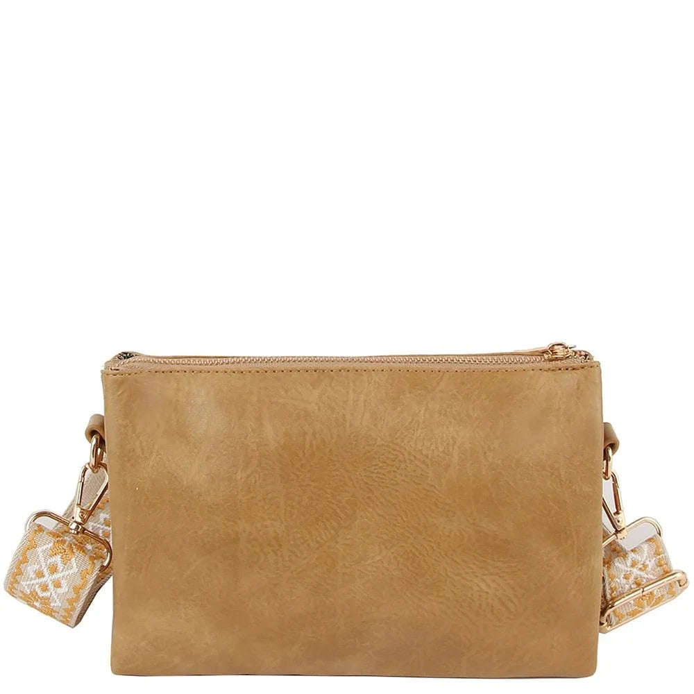 Tan leather crossbody bag clutch with patterned fabric guitar strap design