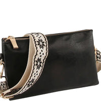 Black leather crossbody bag clutch with decorative patterned guitar strap design